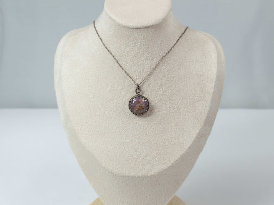 Elevate your style with this handcrafted Agua Nueva Agate pendant necklace. Set in a sterling silver bezel with an open back, this unique gemstone hangs from a delicate silver chain, showcasing nature’s artistry. Shop now for timeless elegance!