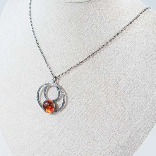 Elegant sterling silver hoop pendant featuring a unique natural amber stone, exuding charm and sophistication. A timeless piece perfect for everyday wear or special occasions
