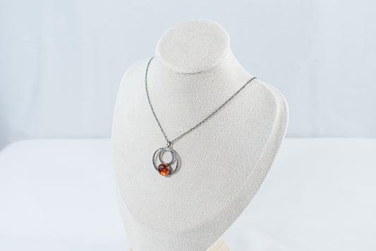 Elegant sterling silver hoop pendant featuring a unique natural amber stone, exuding charm and sophistication. A timeless piece perfect for everyday wear or special occasions