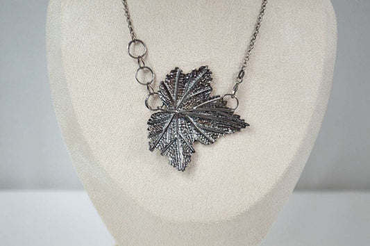 Handcrafted sterling silver necklace featuring an intricately detailed Currant leaf design with realistic veins and texture, exuding elegance and nature-inspired charm.