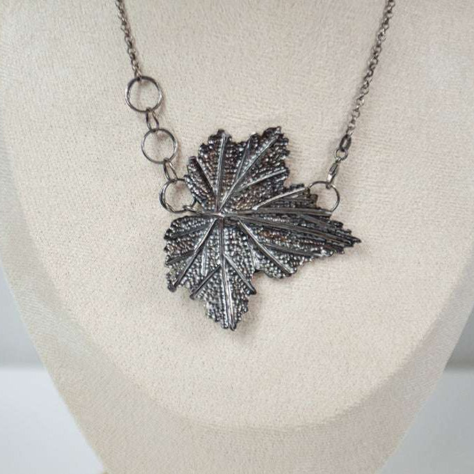 Handcrafted sterling silver necklace featuring an intricately detailed Currant leaf design with realistic veins and texture, exuding elegance and nature-inspired charm.