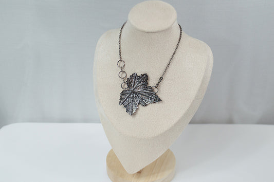 Handcrafted sterling silver necklace featuring an intricately detailed Currant leaf design with realistic veins and texture, exuding elegance and nature-inspired charm.