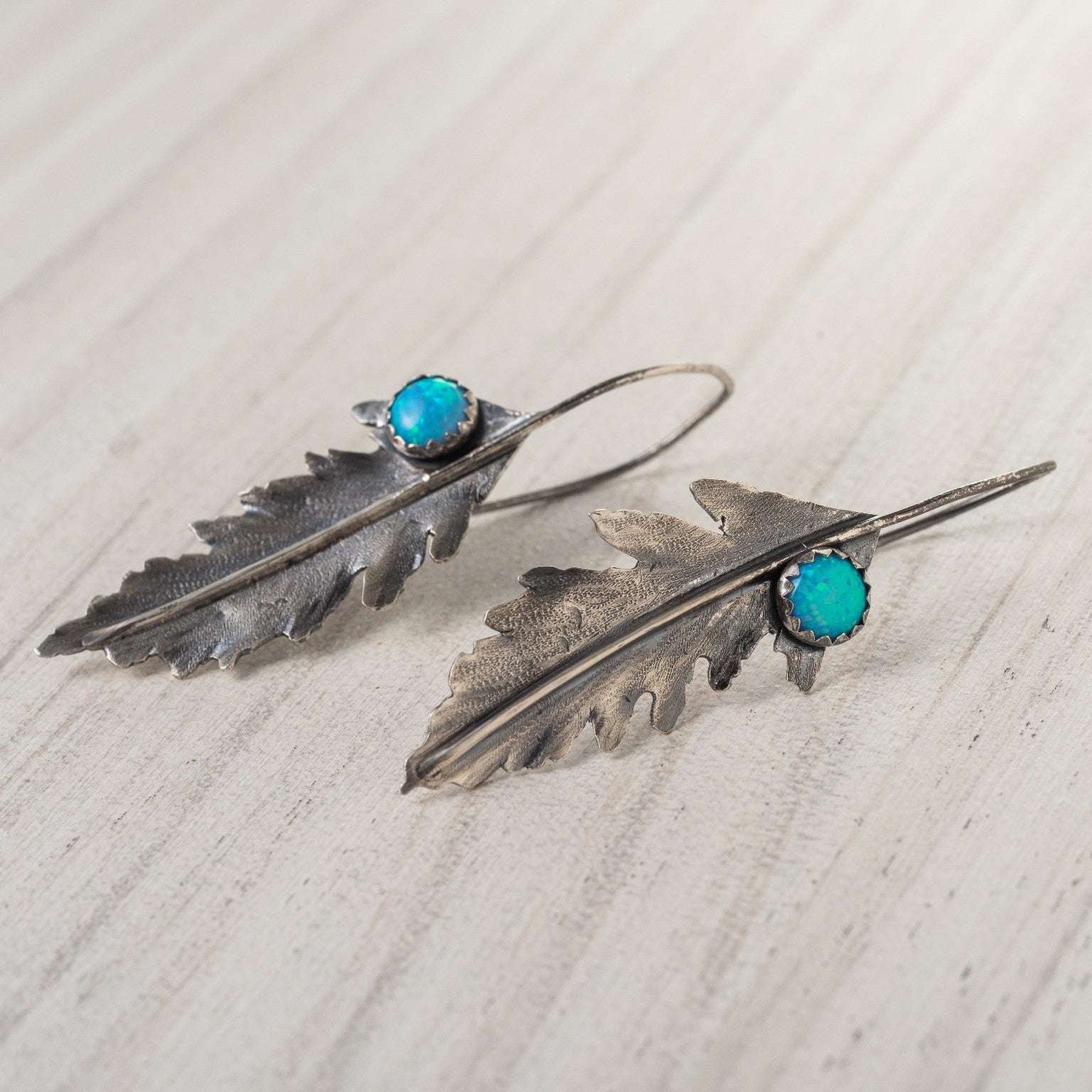Opal Fern Leaf Earrings crafted from sterling silver, featuring delicate fern-shaped designs with lab-created opal accents