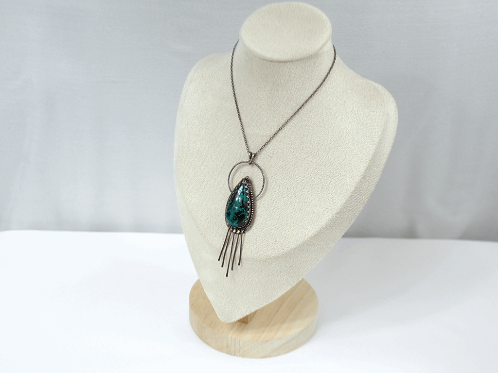 Handcrafted 925 sterling silver pendant featuring a vibrant drop-shaped Chrysocolla stone, accented with delicate silver fringe for playful movement and bohemian charm.