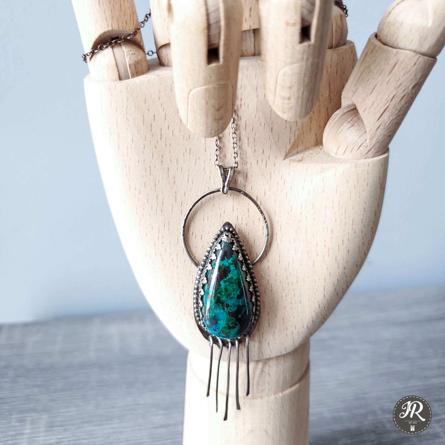 Handcrafted 925 sterling silver pendant featuring a vibrant drop-shaped Chrysocolla stone, accented with delicate silver fringe for playful movement and bohemian charm.