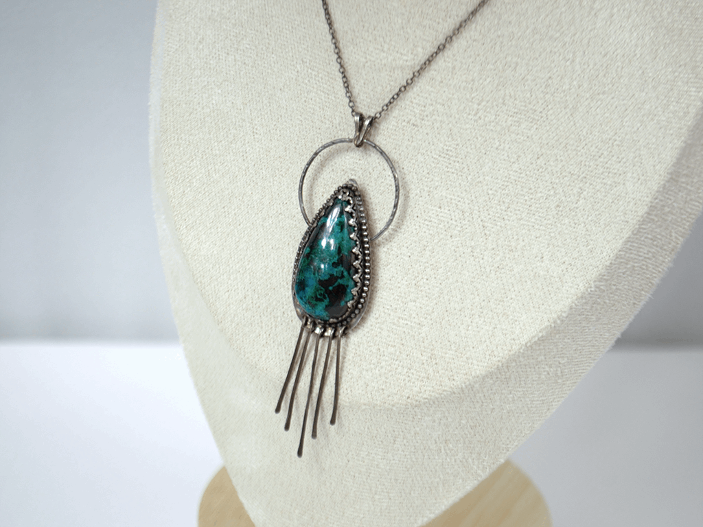Handcrafted 925 sterling silver pendant featuring a vibrant drop-shaped Chrysocolla stone, accented with delicate silver fringe for playful movement and bohemian charm.