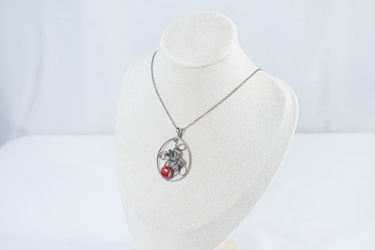 Handcrafted sterling silver garden pendant necklace featuring a delicate leaf design and a vibrant red jasper gemstone, nature-inspired artisan jewelry.
