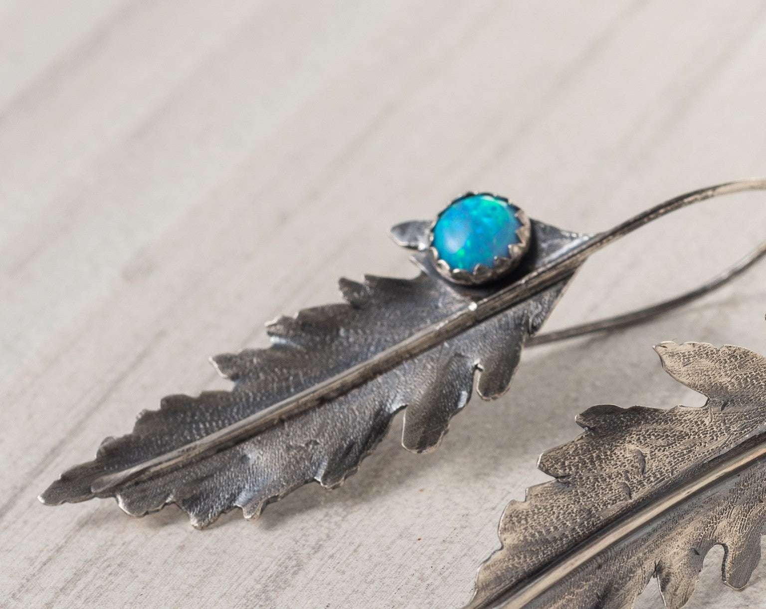 Opal Fern Leaf Earrings crafted from sterling silver, featuring delicate fern-shaped designs with lab-created opal accents