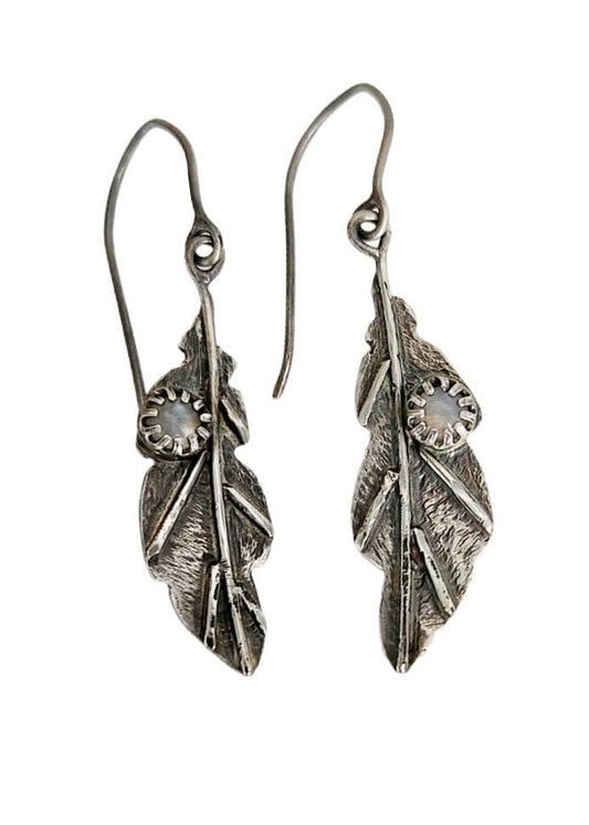 Elegant leaf-shaped earrings crafted from sterling silver, adorned with radiant rainbow moonstone gems