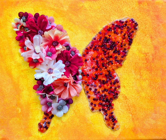 Butterfly-shaped art made of flowers on a yellow background