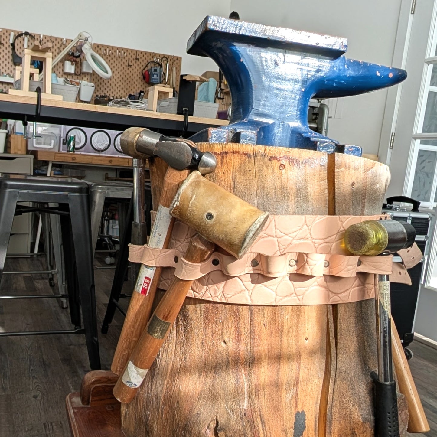 Wooden anvil with tools in a workshop setting
