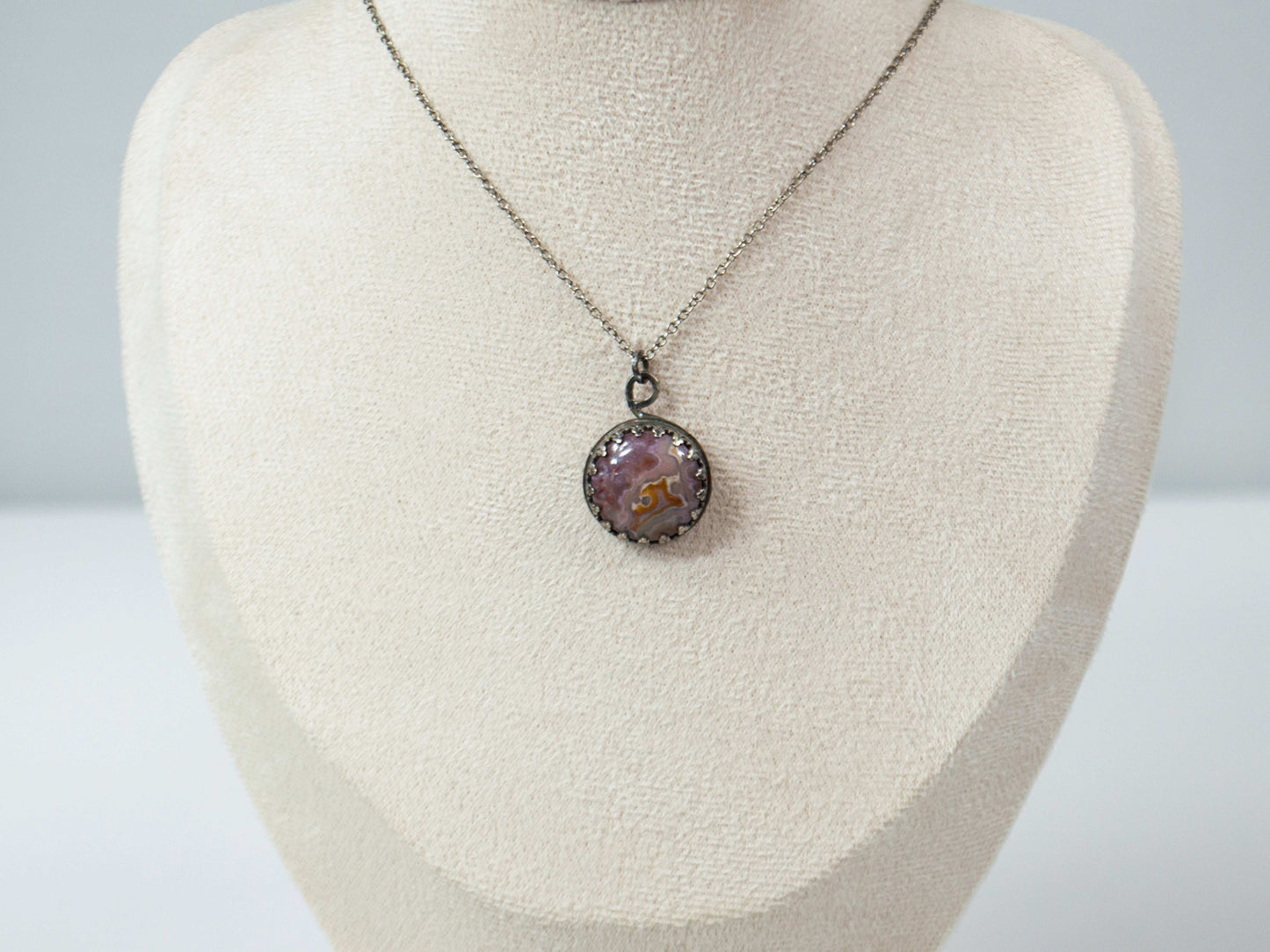 Elevate your style with this handcrafted Agua Nueva Agate pendant necklace. Set in a sterling silver bezel with an open back, this unique gemstone hangs from a delicate silver chain, showcasing nature’s artistry. Shop now for timeless elegance!
