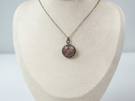 Elevate your style with this handcrafted Agua Nueva Agate pendant necklace. Set in a sterling silver bezel with an open back, this unique gemstone hangs from a delicate silver chain, showcasing nature’s artistry. Shop now for timeless elegance!
