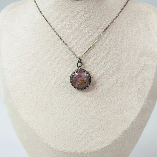 Elevate your style with this handcrafted Agua Nueva Agate pendant necklace. Set in a sterling silver bezel with an open back, this unique gemstone hangs from a delicate silver chain, showcasing nature’s artistry. Shop now for timeless elegance!