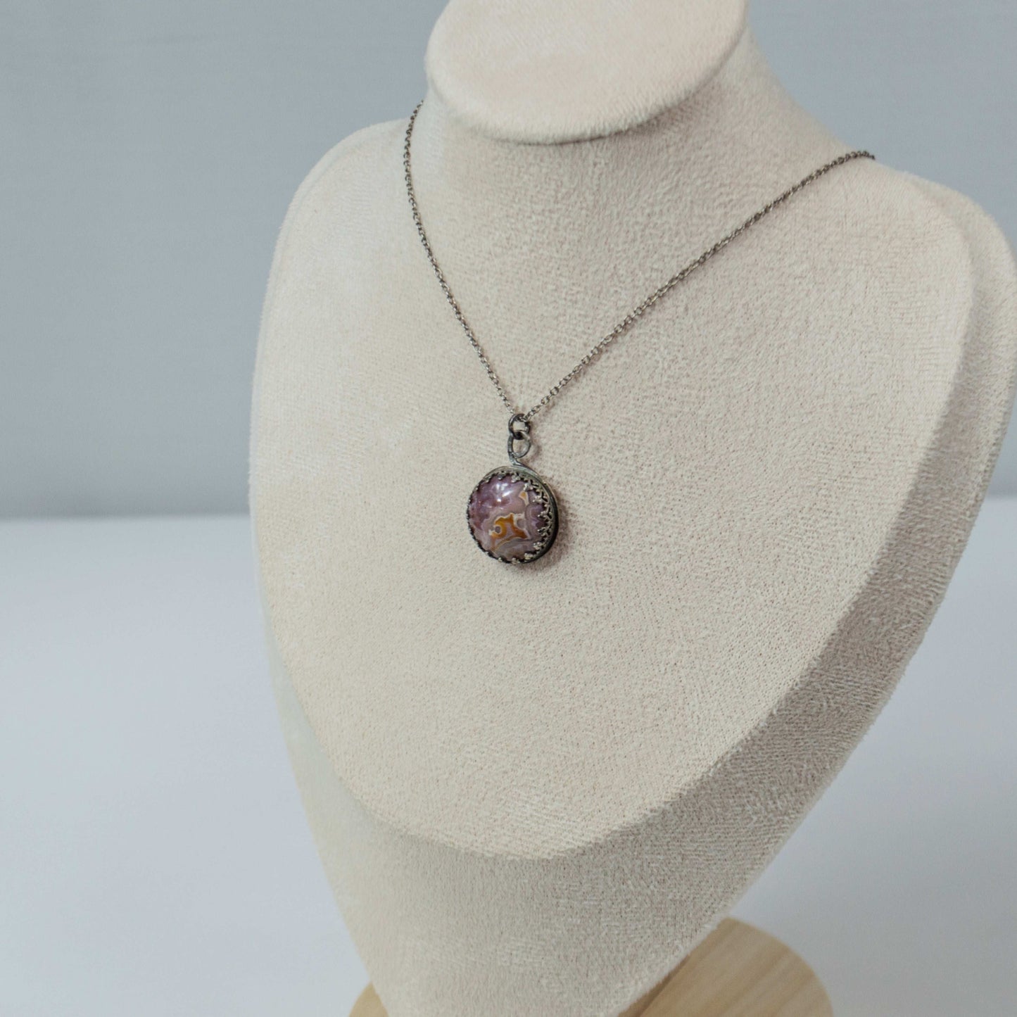 Elevate your style with this handcrafted Agua Nueva Agate pendant necklace. Set in a sterling silver bezel with an open back, this unique gemstone hangs from a delicate silver chain, showcasing nature’s artistry. Shop now for timeless elegance!