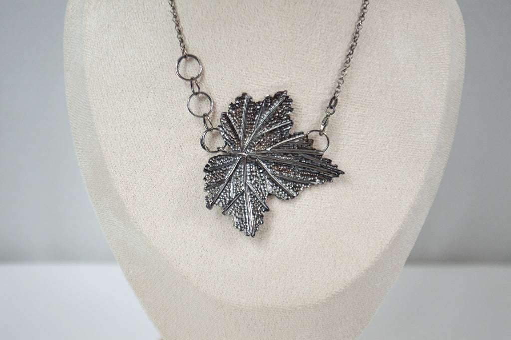 Handcrafted sterling silver necklace featuring an intricately detailed Currant leaf design with realistic veins and texture, exuding elegance and nature-inspired charm.