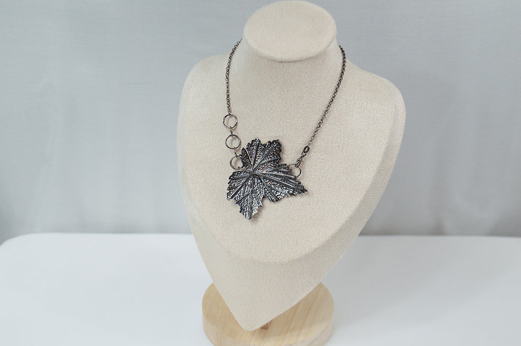Handcrafted sterling silver necklace featuring an intricately detailed Currant leaf design with realistic veins and texture, exuding elegance and nature-inspired charm.
