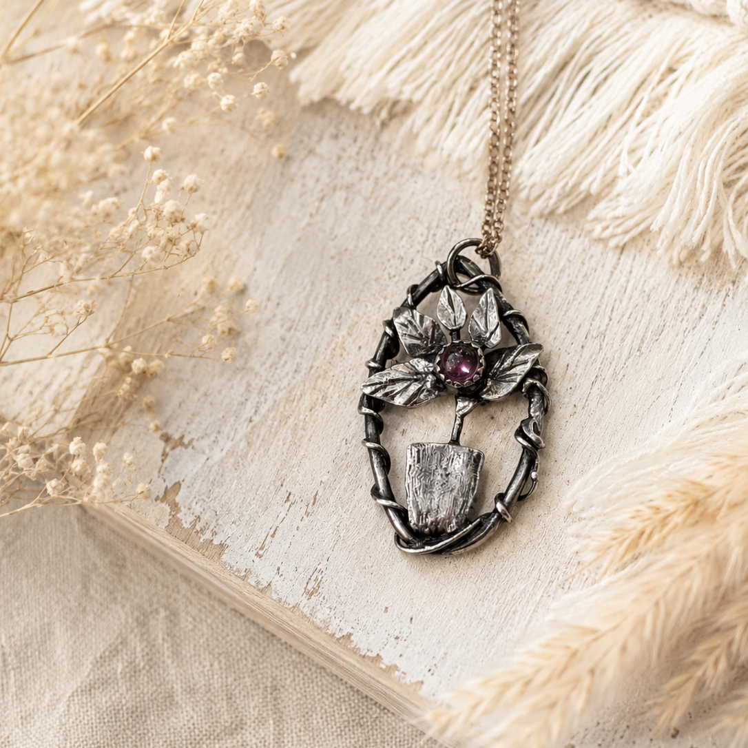 Necklace with a pendant on a textured beige surface