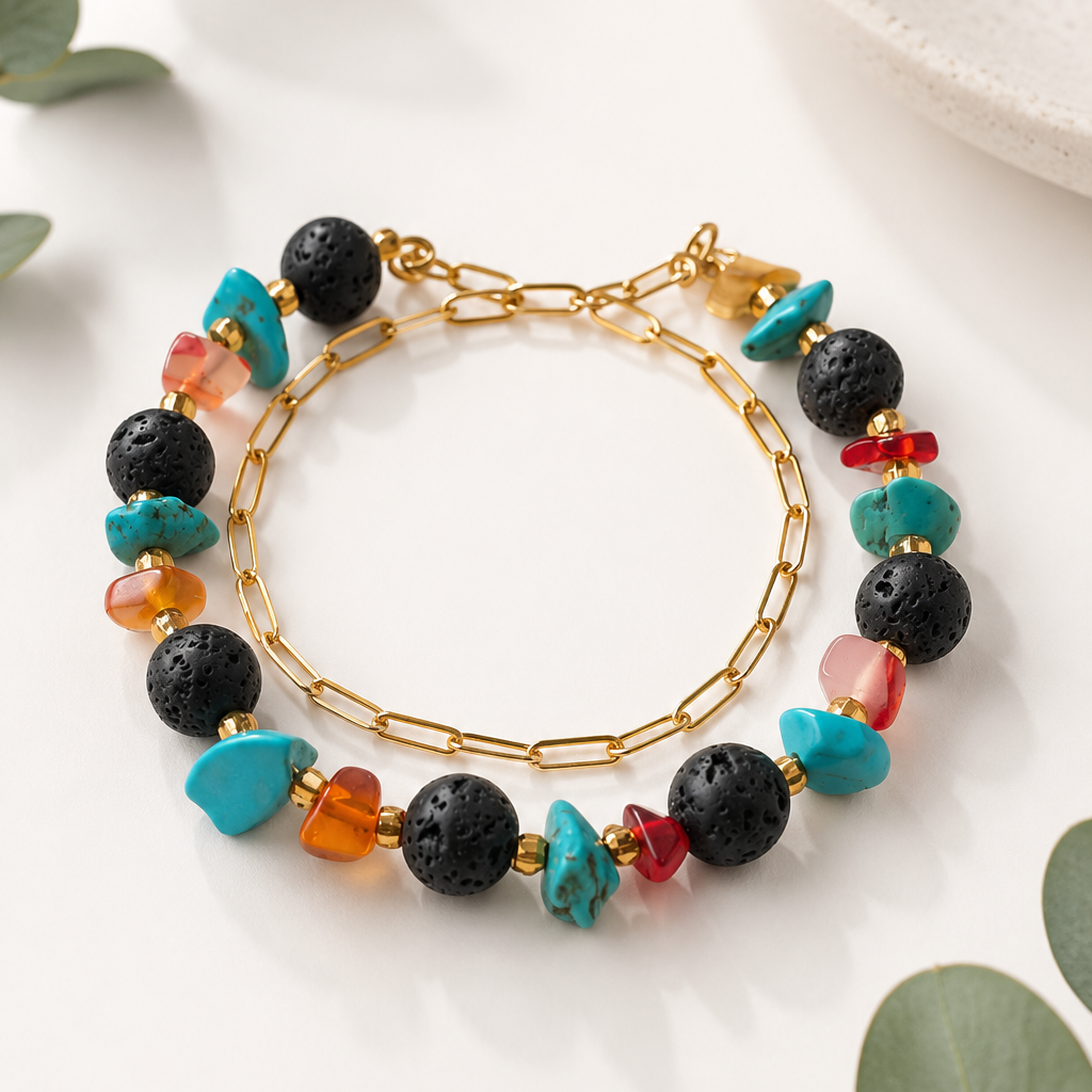 Bracelet with multicolored beads on a white surface with green leaves